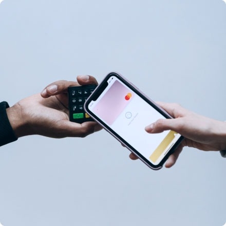 A person holding a credit card and testing the payment gateway of a banking solution.