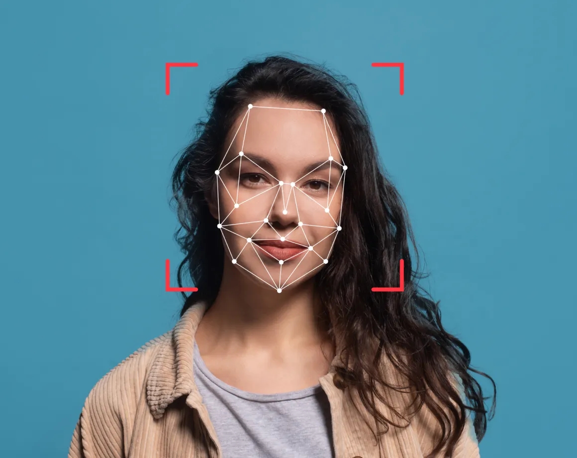 Face with deepfake detection mesh overlay and red tracking markers