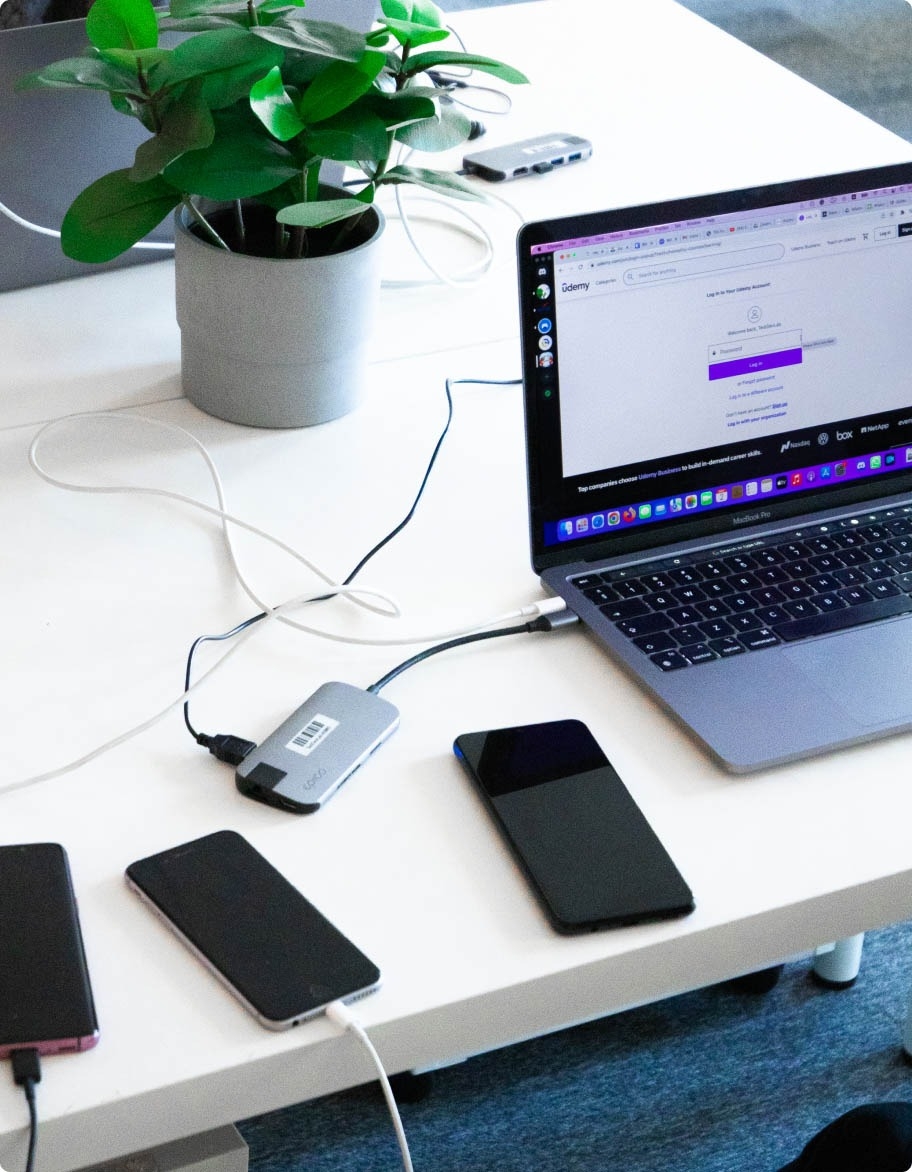 Multiple devices on the desk for mobile app testing purposes.