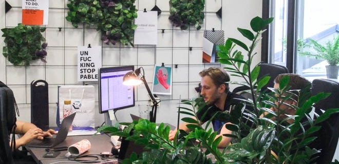 Three software engineers discussing project details.