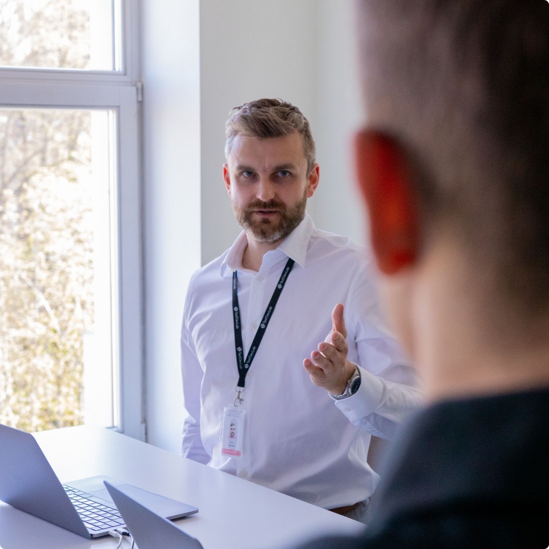 Two people talking about the latest updates regarding ISO advisory services.