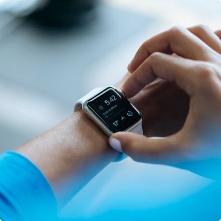 A person pressing a button on their smartwatch.