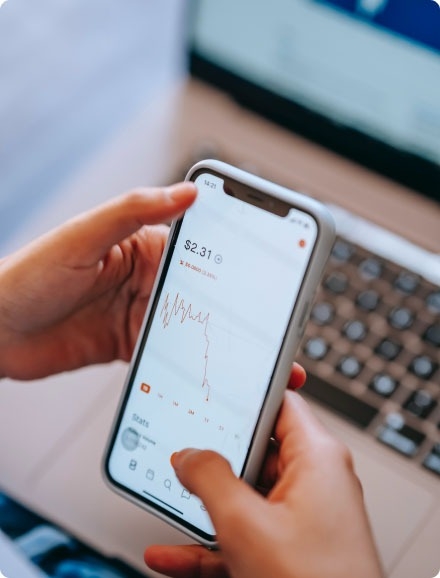 A person checking the latest stock changes on a mobile phone.