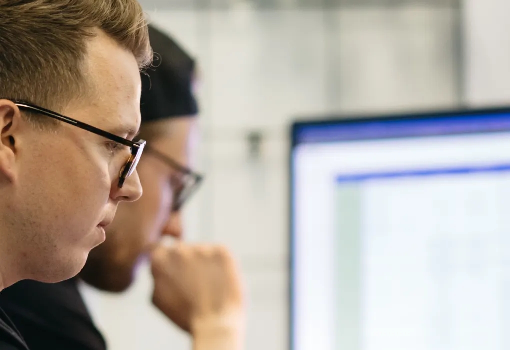 QA engineer performing manual compatibility testing on multiple devices.