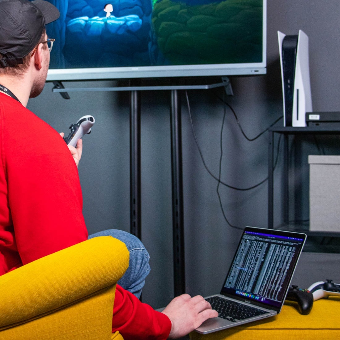 Software quality assurance engineer performing game testing with a PS5 controller.