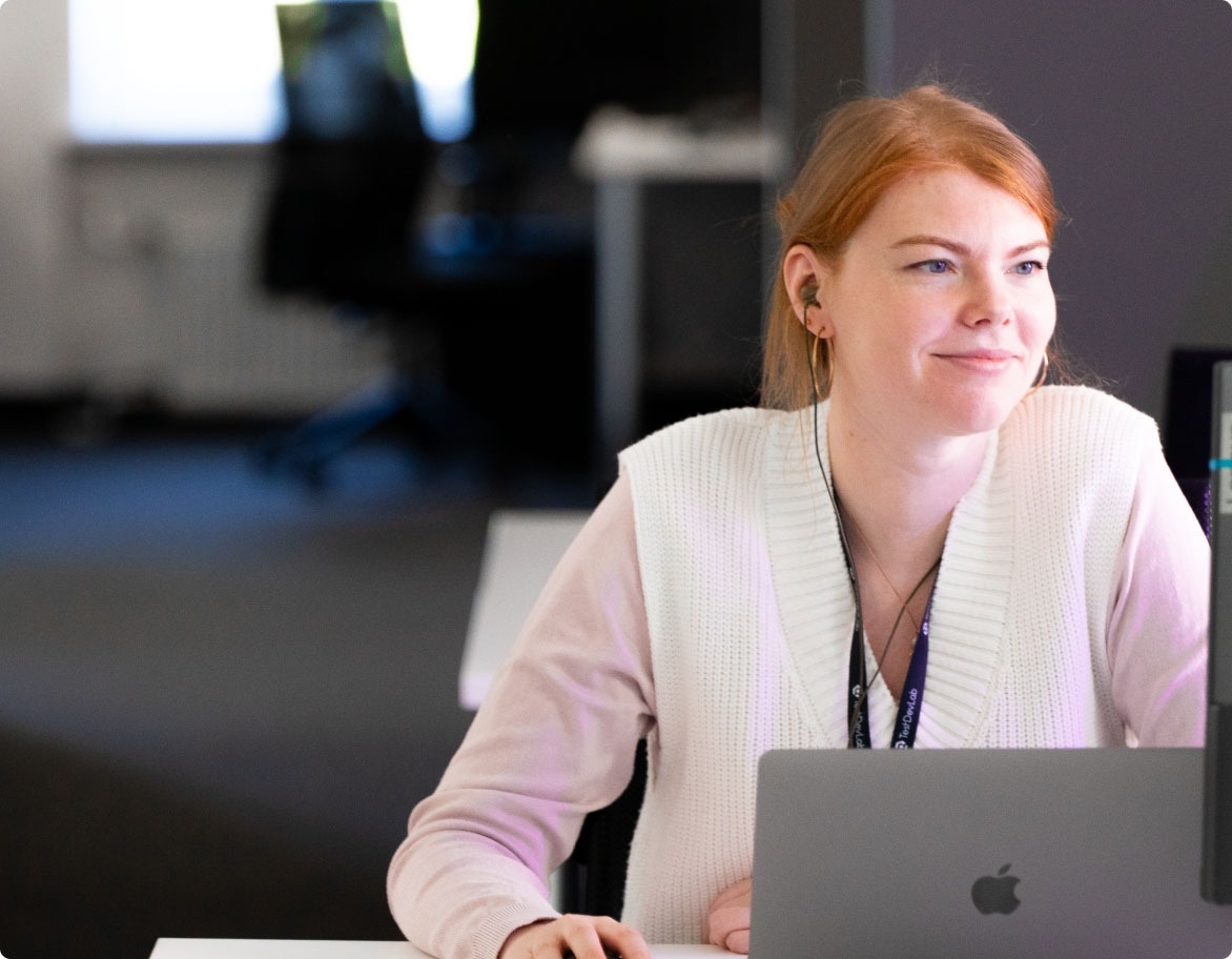 A QA engineer working with a laptop.