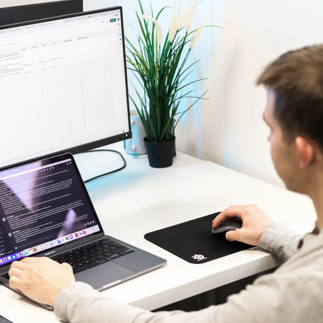 A QA engineer working with a laptop.
