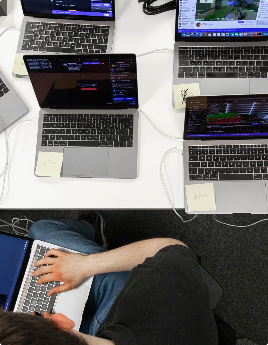 QA engineer with multiple devices used for software testing.