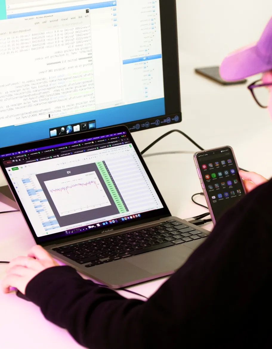 QA engineer testing software compatibility across desktop, laptop, and mobile devices.