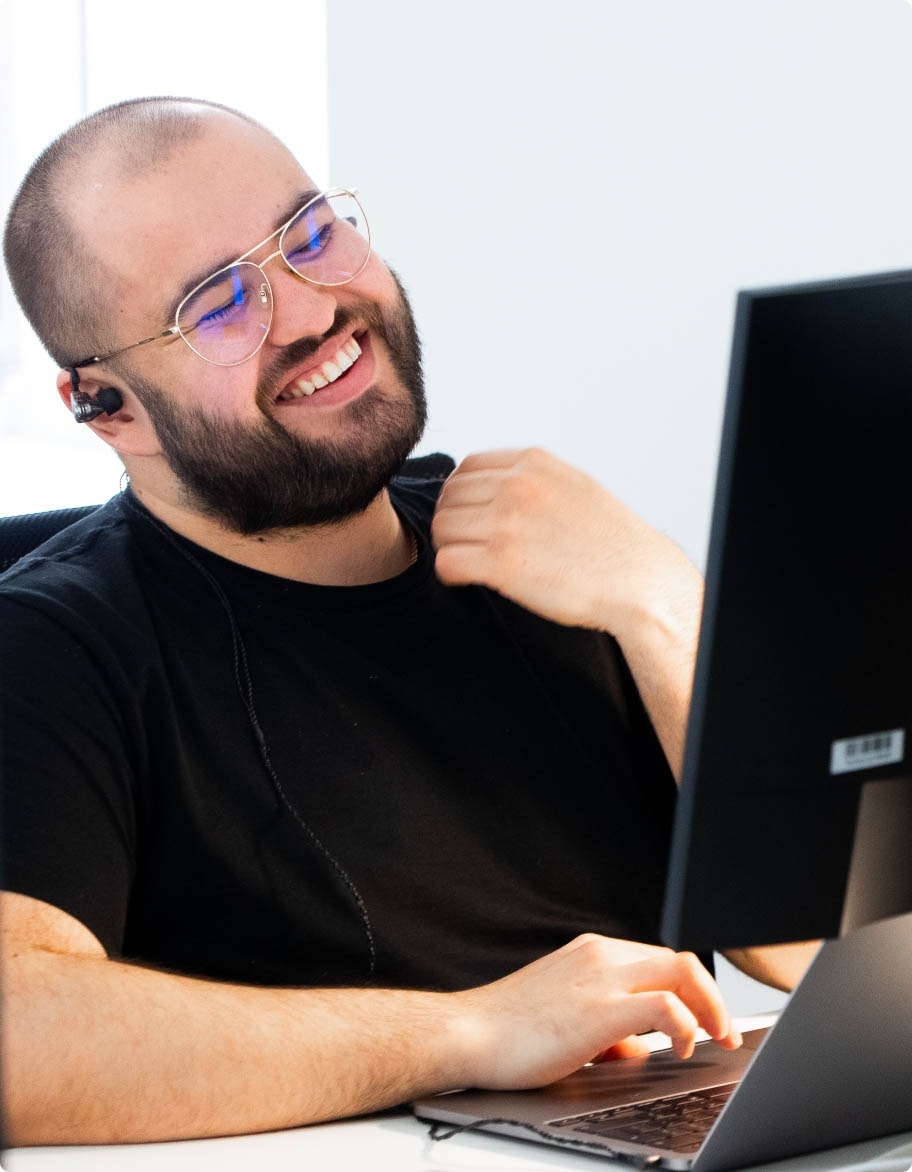 Smiling QA engineer on a call with a client.