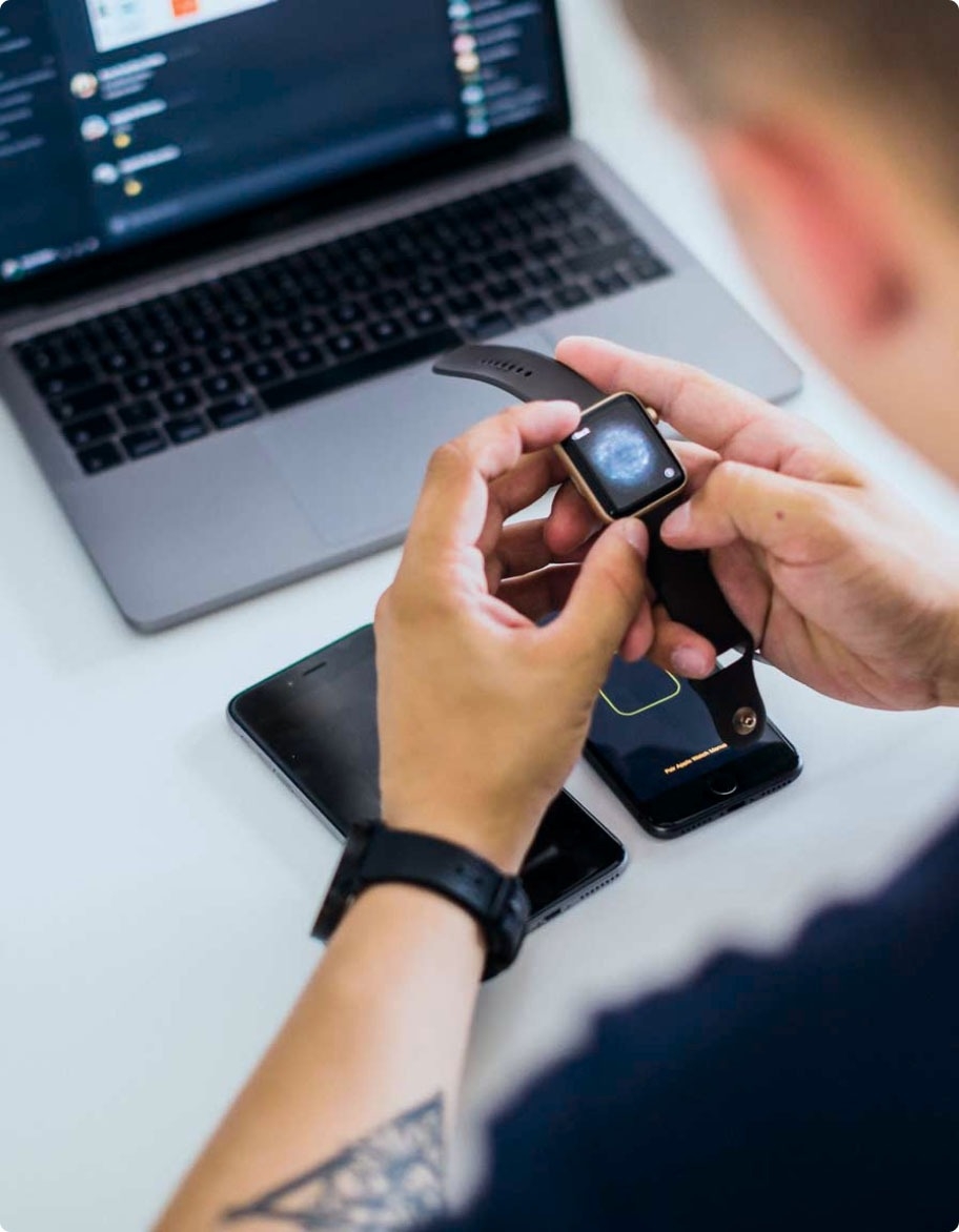 A QA engineer testing a security and authentication solution on a smartwatch.