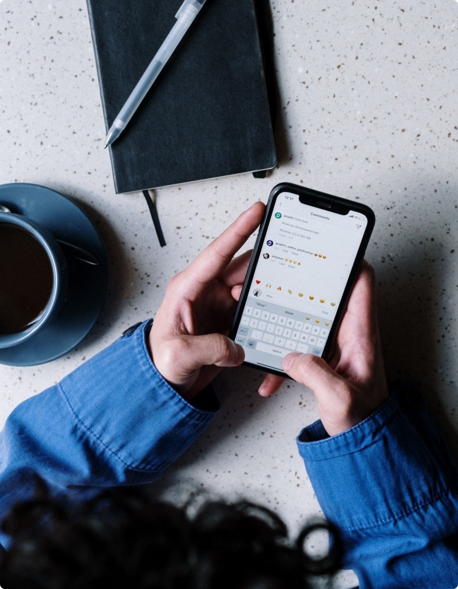 A QA engineer manually testing a messaging application on a mobile phone.