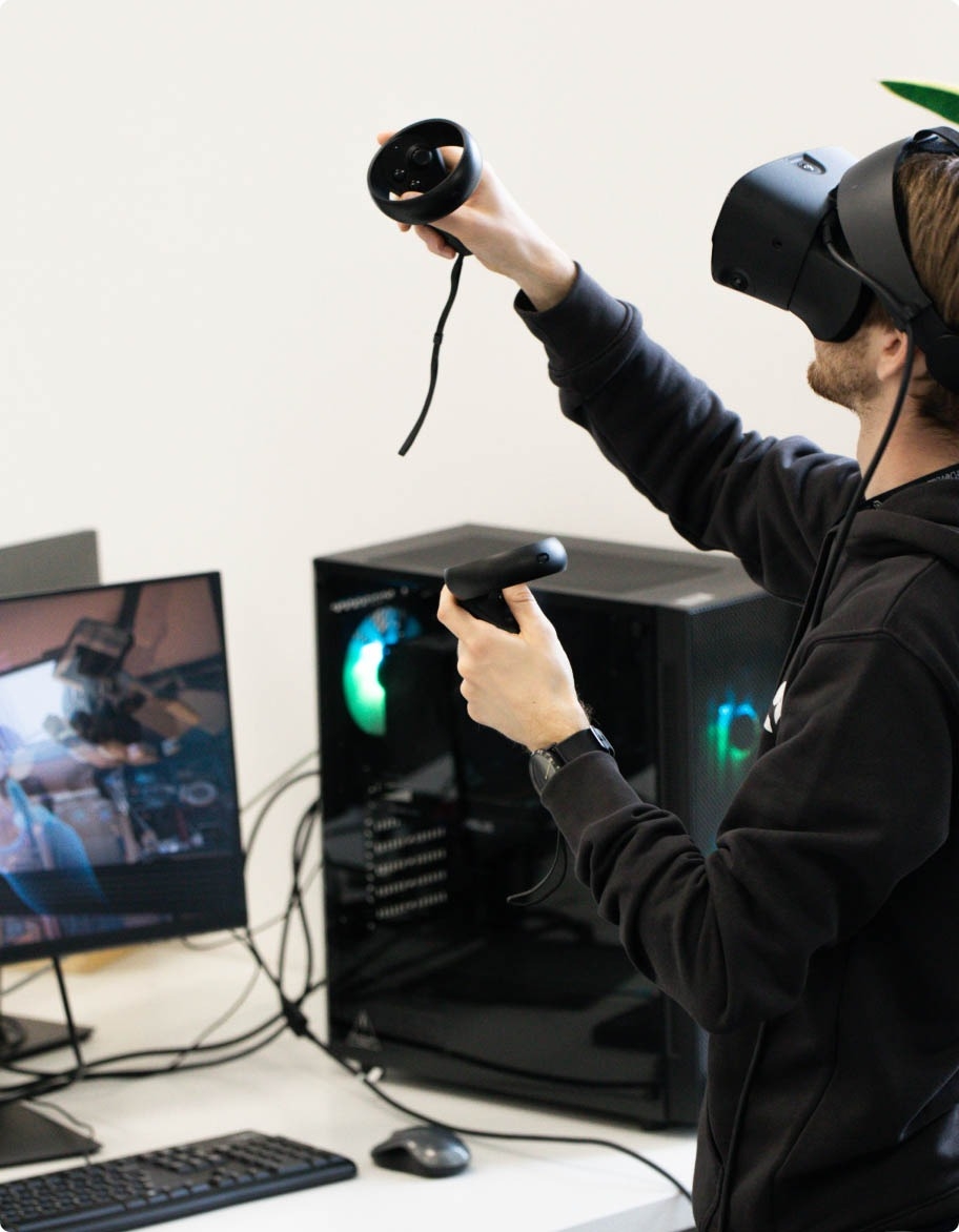 QA engineer wearing a VR headset and controllers while testing an AR/VR solution.