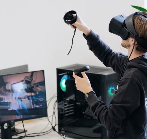 Quality assurance expert wearing a VR headset and performing software testing activities.