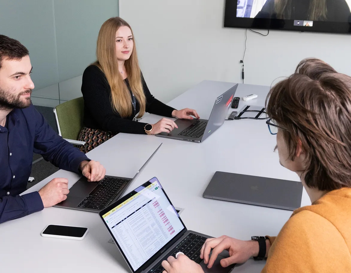 QA team in a lively meeting discussing project details.
