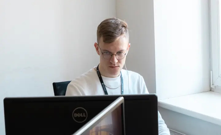 QA team reviewing regression test results on a monitor