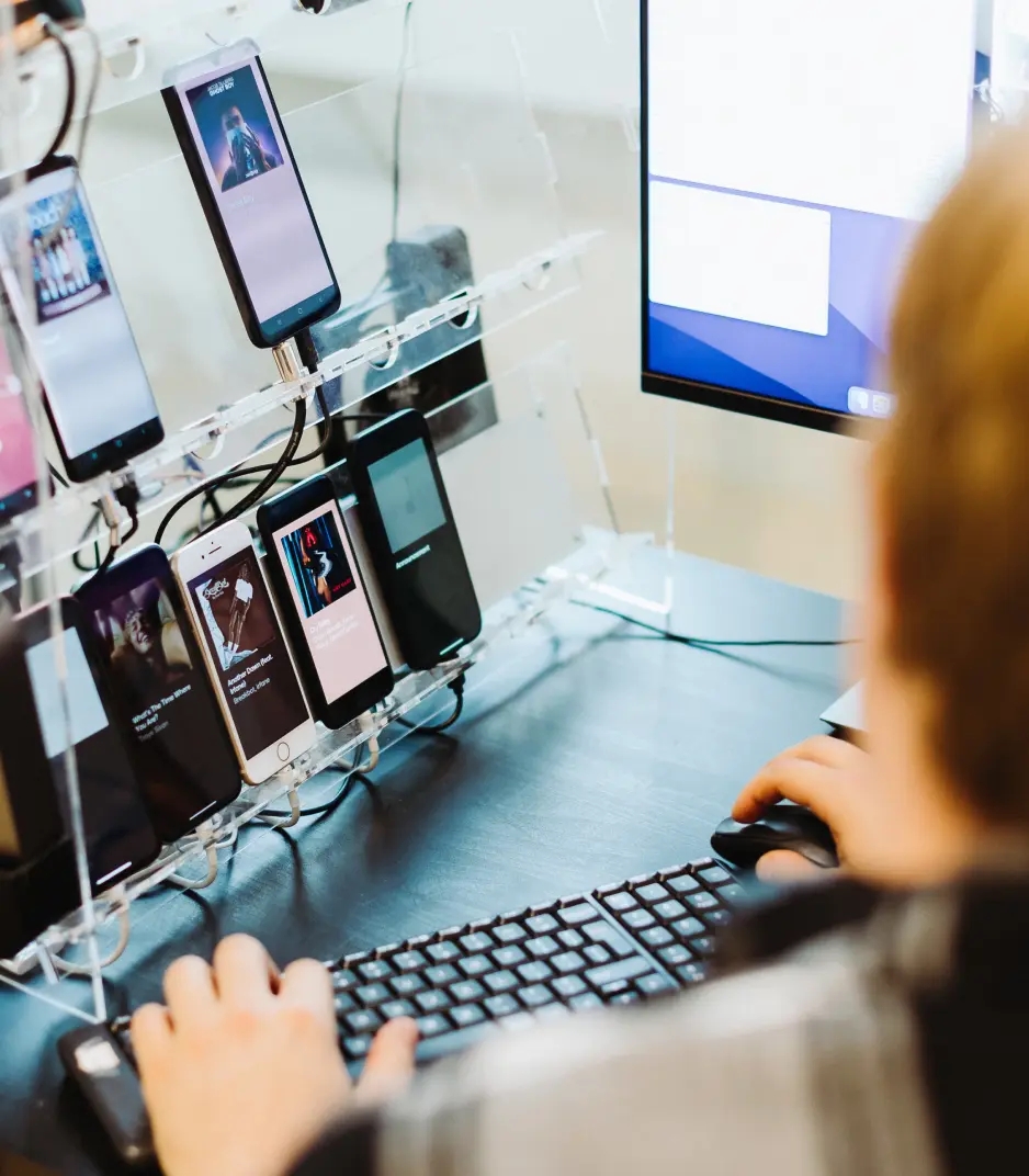 QA engineer working with multiple mobile devices in a test environment