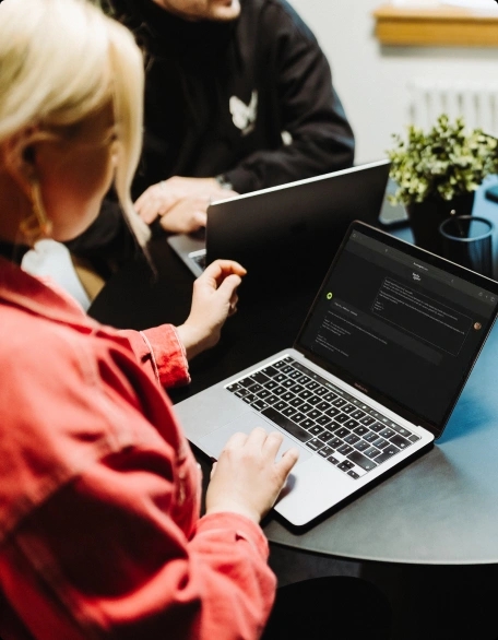 QA engineers collaborating on AI-augmented software testing at TestDevLab
