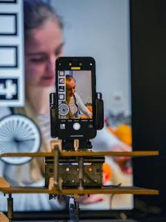 Mobile phone in a holder, filming monitor.