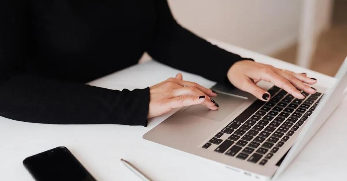 A person is working on her computer