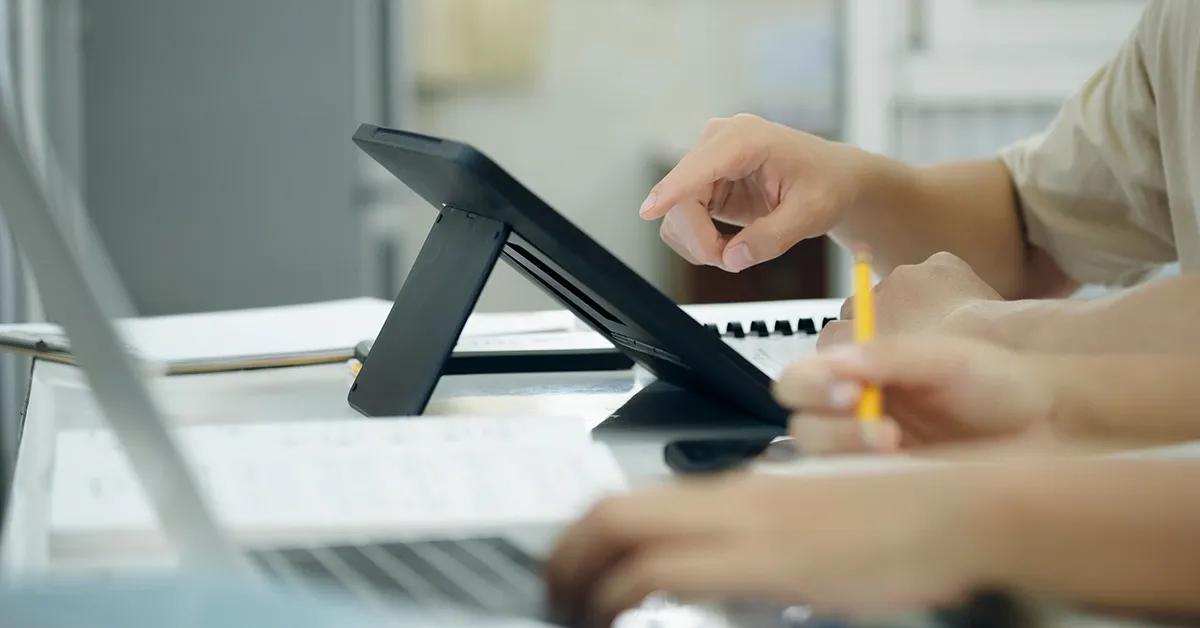 Closeup of hand tapping on tablet device