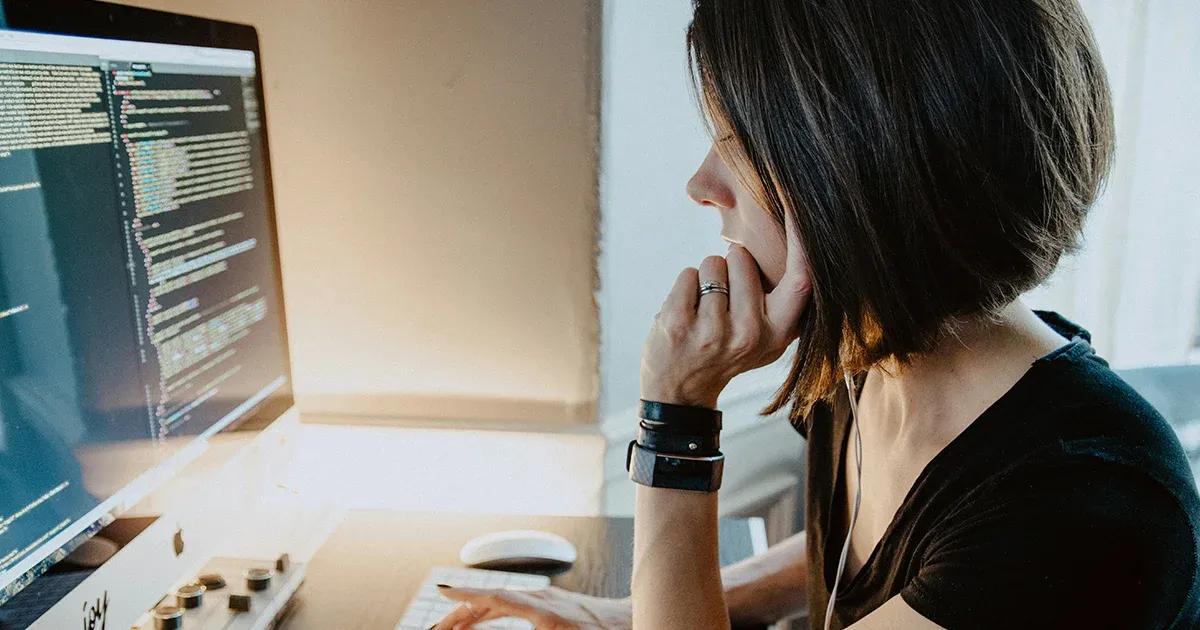 Woman reviewing code on her computer.