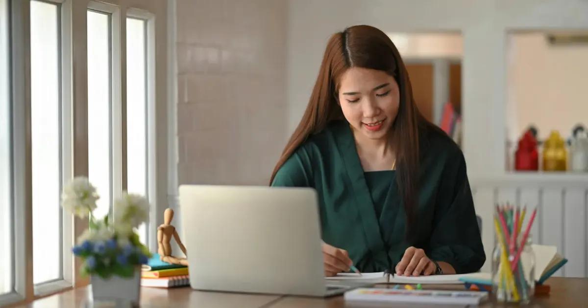 Woman taking notes in a notebook.