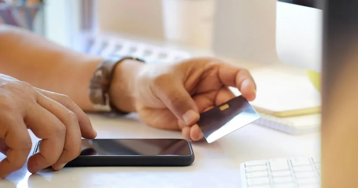 Man using his bank card for online purchase