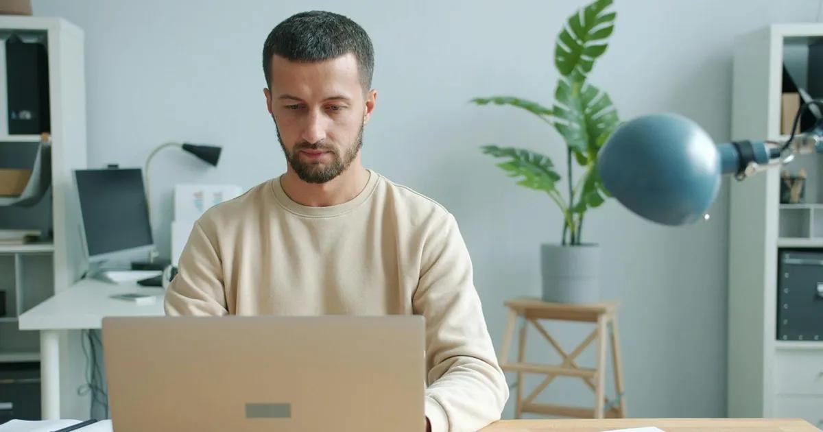 Man working on laptop in office space
