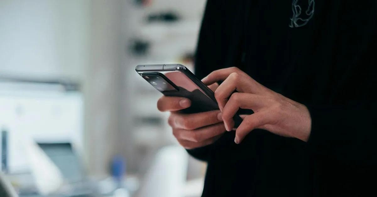 Person holding and using a smartphone