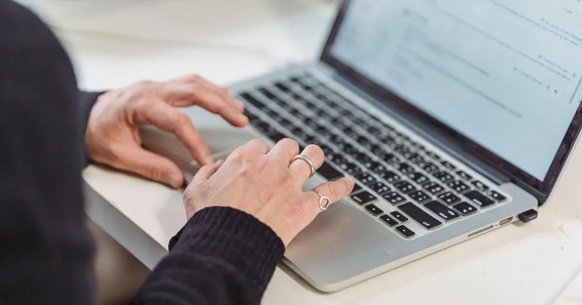 Person typing on laptop