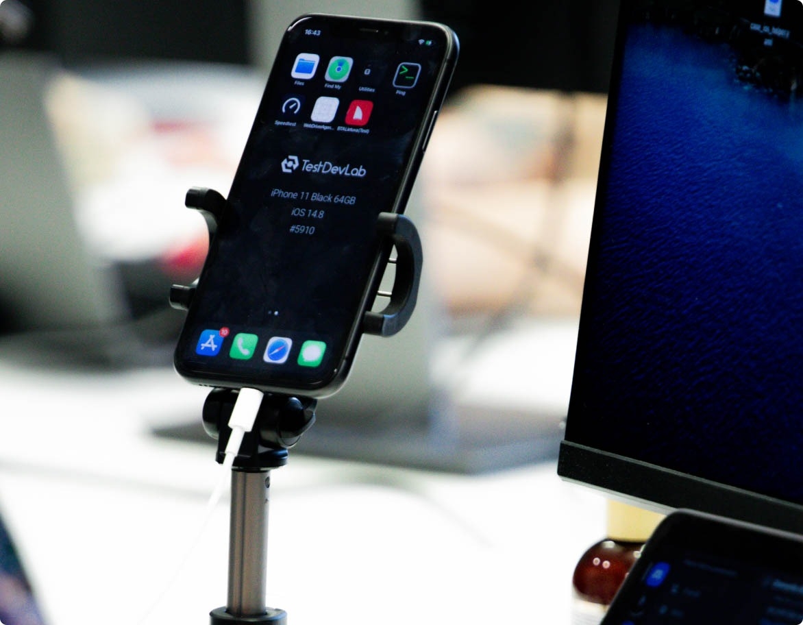 Device in a phone holder ready to be used for mobile application testing purposes.