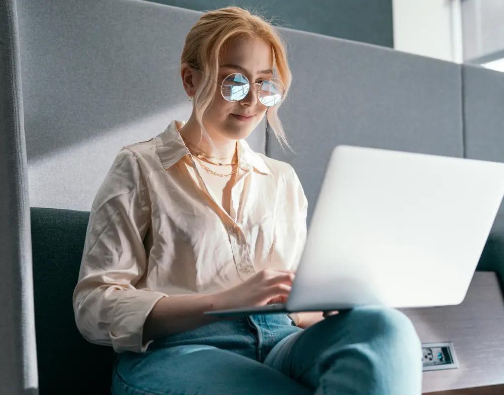 Engineer working on a laptop in an office booth