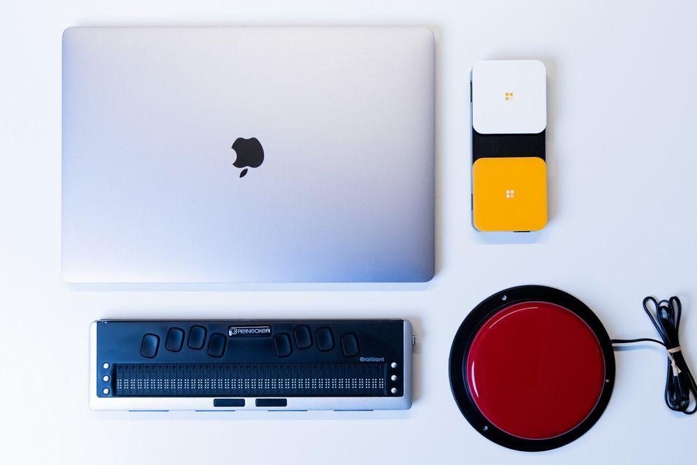 Picture of a laptop and different types of adaptive switches used for accessibility testing