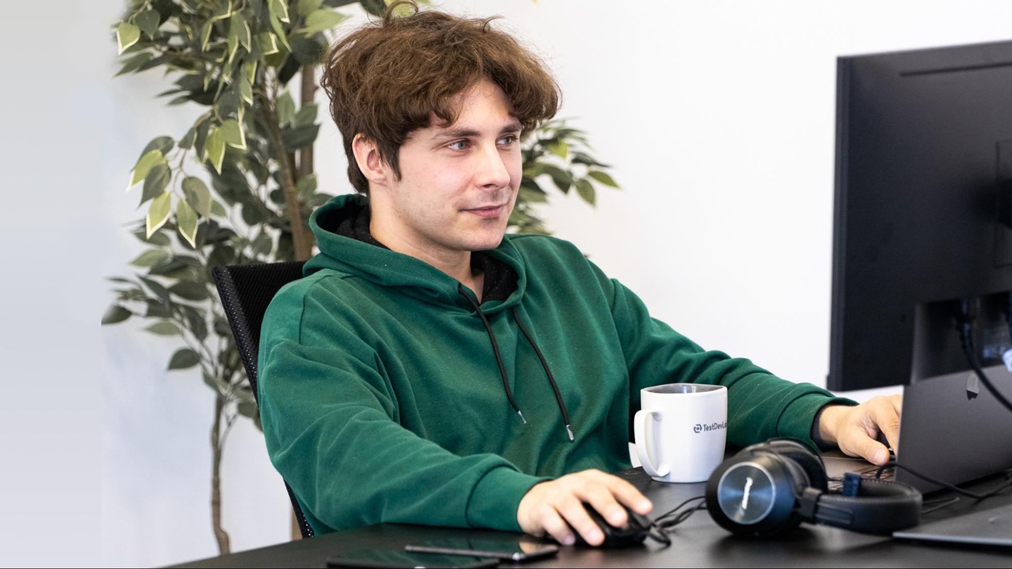 TestDevLav QA engineer sitting at desk performing web app testing