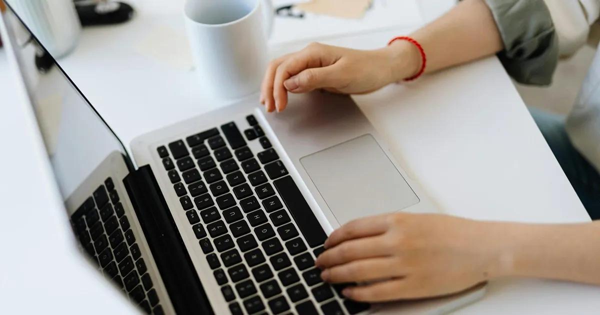 Person typing on a laptop at a desk