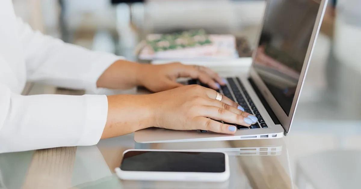 Person typing on laptop computer