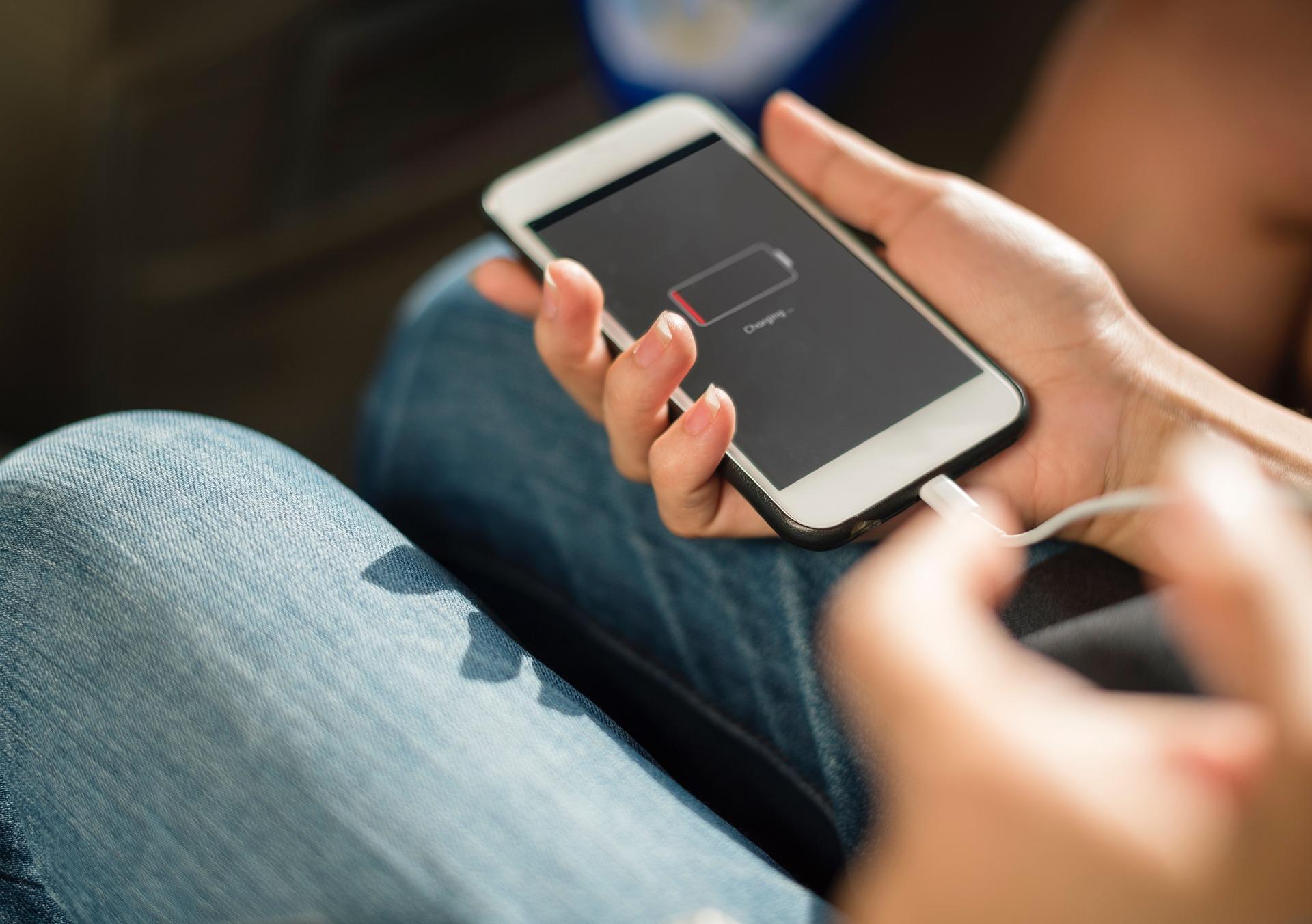 Person connecting phone to charger